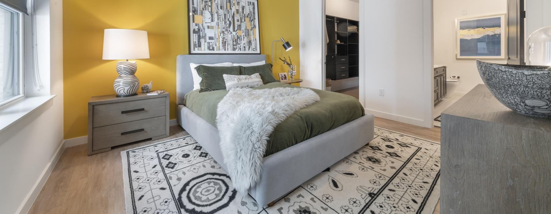 a bedroom with a bed and a lamp