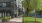a sidewalk and trees next to a street