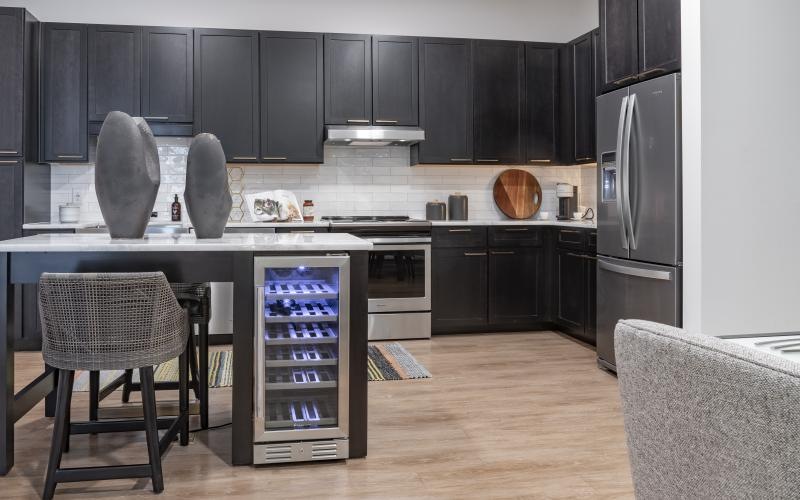 a kitchen with black cabinets