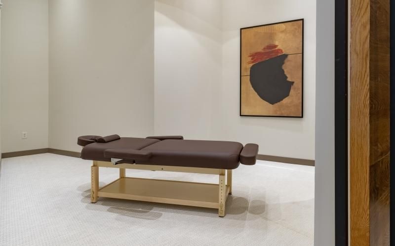 a room with a message table and a painting on the wall