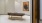 a room with a message table and a painting on the wall